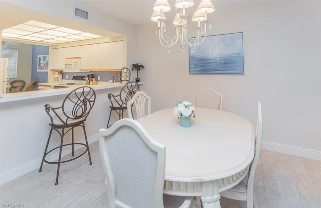 a view of a dining room with furniture and chandelier