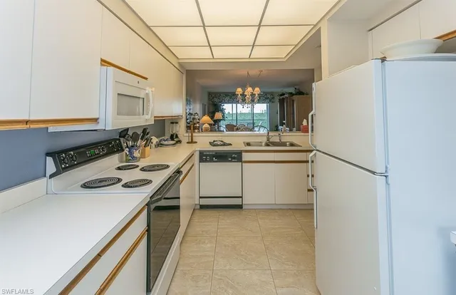 a kitchen with a sink appliances and cabinets