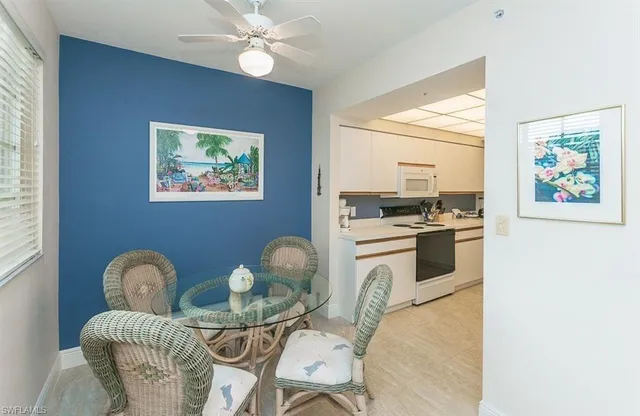 a kitchen with stainless steel appliances granite countertop a stove a sink and a dining table with wooden floor