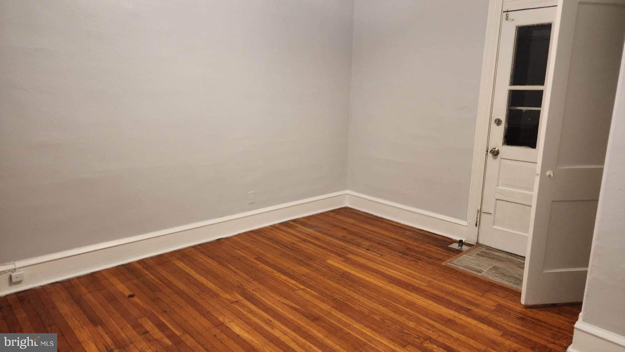 234 Long Lane Upper Darby, PA 19082 - Photo 20 of 29 an empty room with wooden floor and white walls