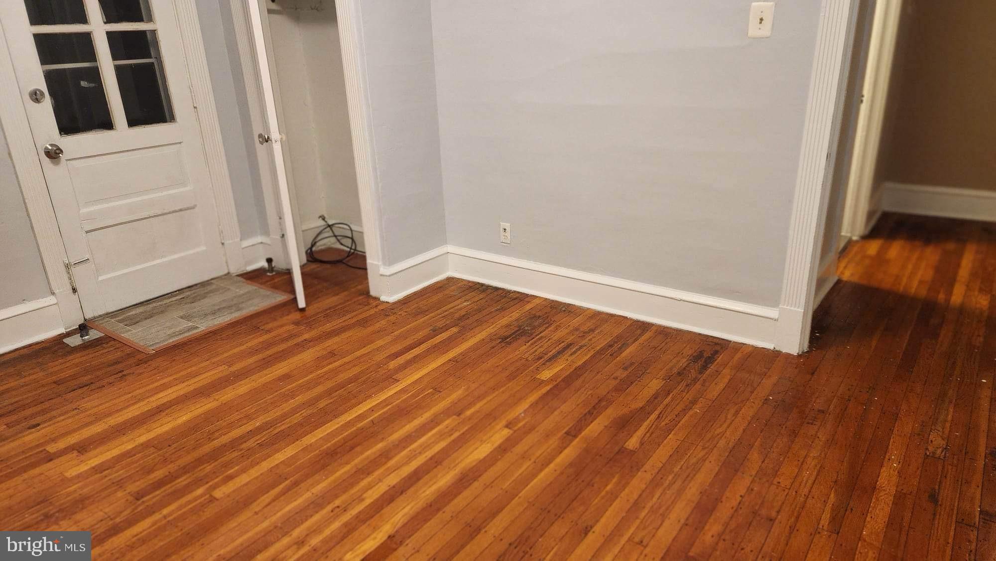 234 Long Lane Upper Darby, PA 19082 - Photo 21 of 29 a view of an empty room with wooden floor and a window