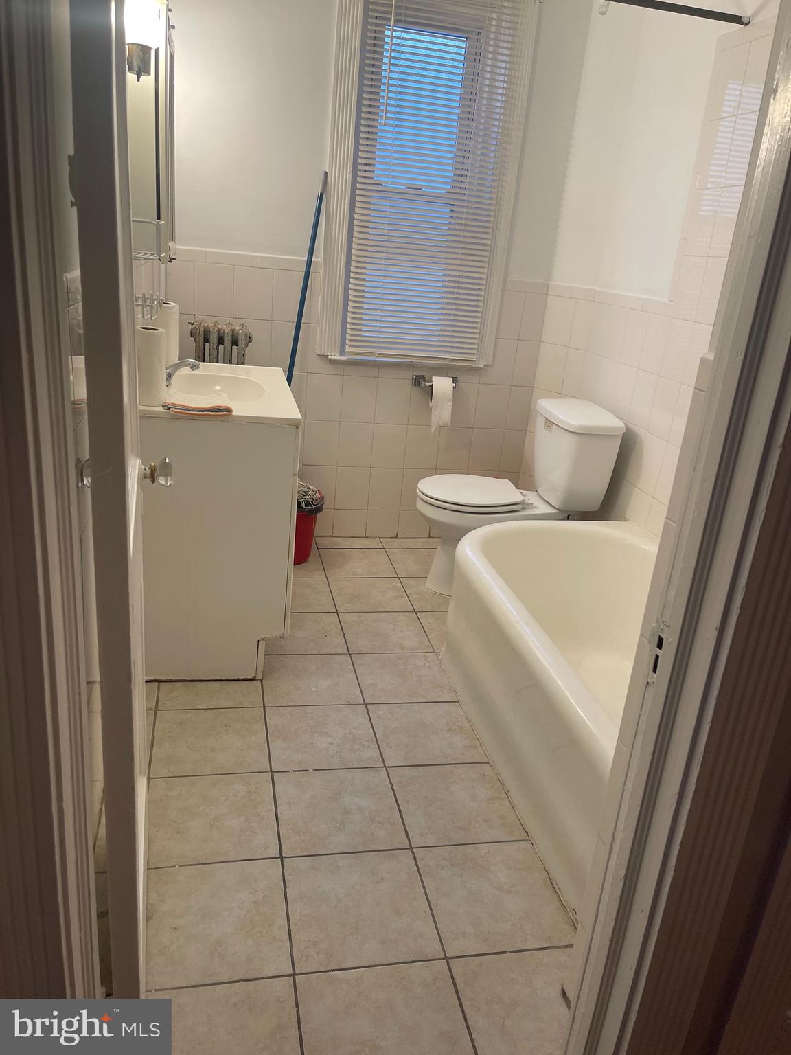 234 Long Lane Upper Darby, PA 19082 - Photo 25 of 29 a bathroom with a sink toilet and mirror