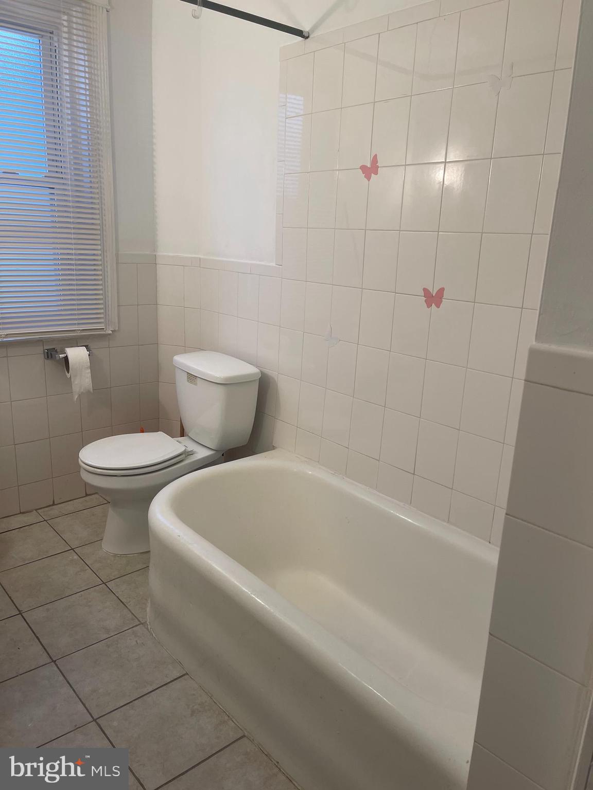 234 Long Lane Upper Darby, PA 19082 - Photo 26 of 29 a white bath tub sitting next to a white toilet