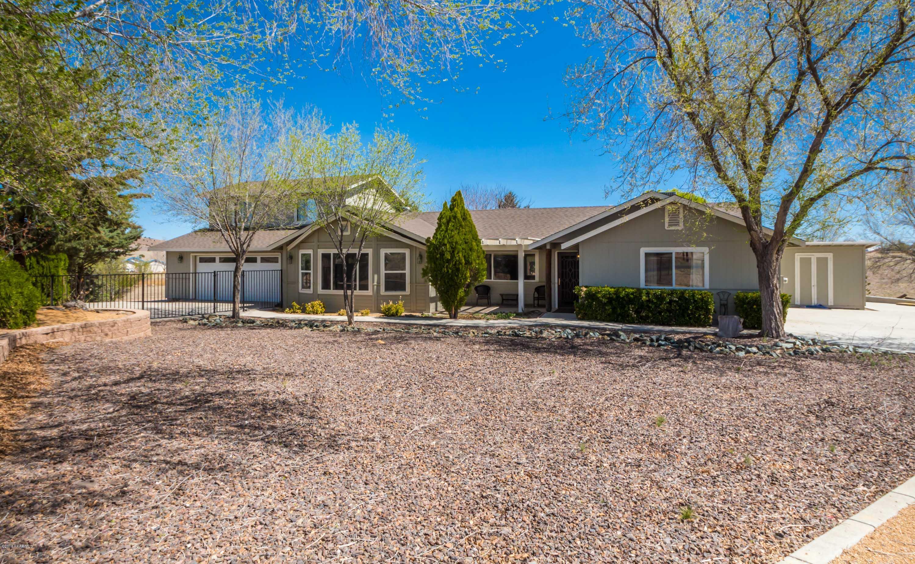 3887 North Reed Road Chino Valley, AZ 86323 - Photo 1 of 18 a front view of a house with a yard