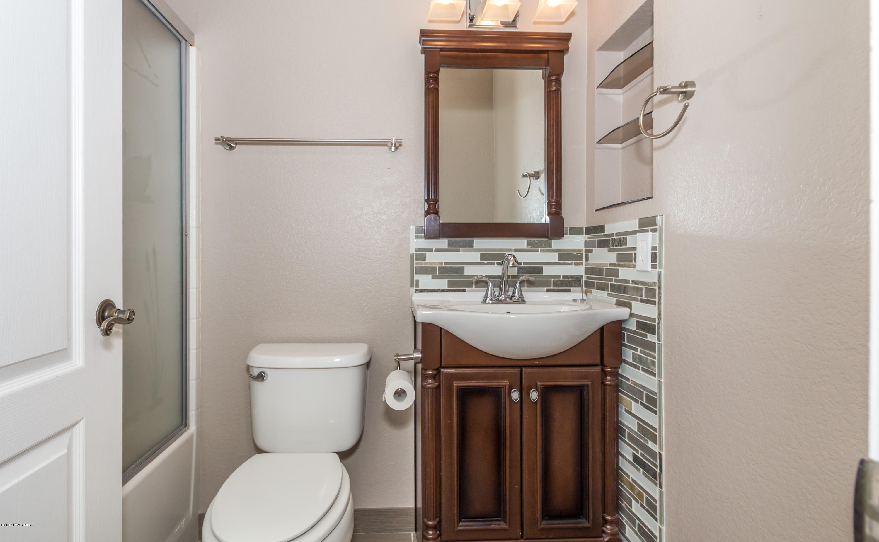 3887 North Reed Road Chino Valley, AZ 86323 - Photo 12 of 18 a bathroom with a toilet sink and mirror