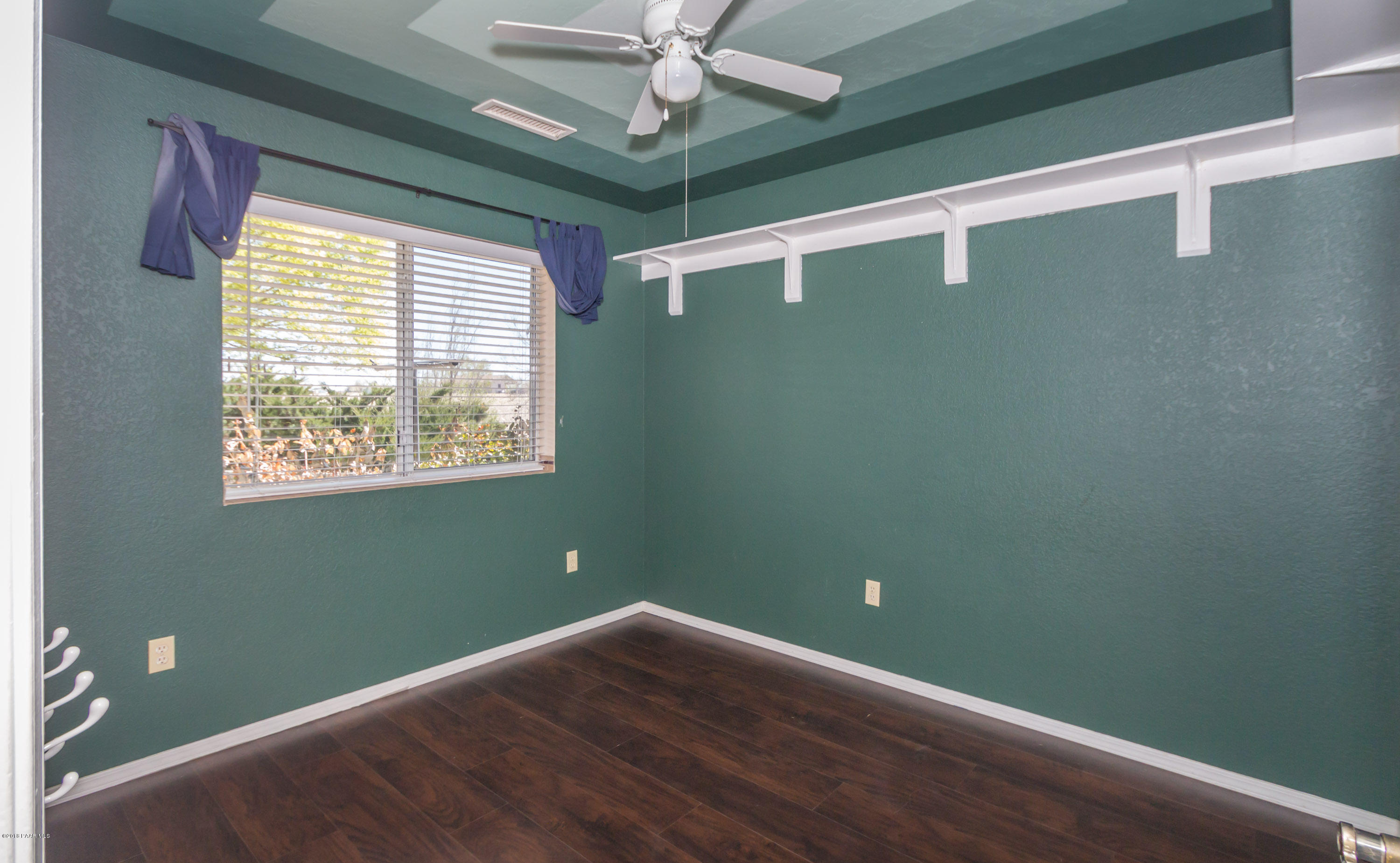3887 North Reed Road Chino Valley, AZ 86323 - Photo 13 of 18 a view of empty room with wooden floor and fan