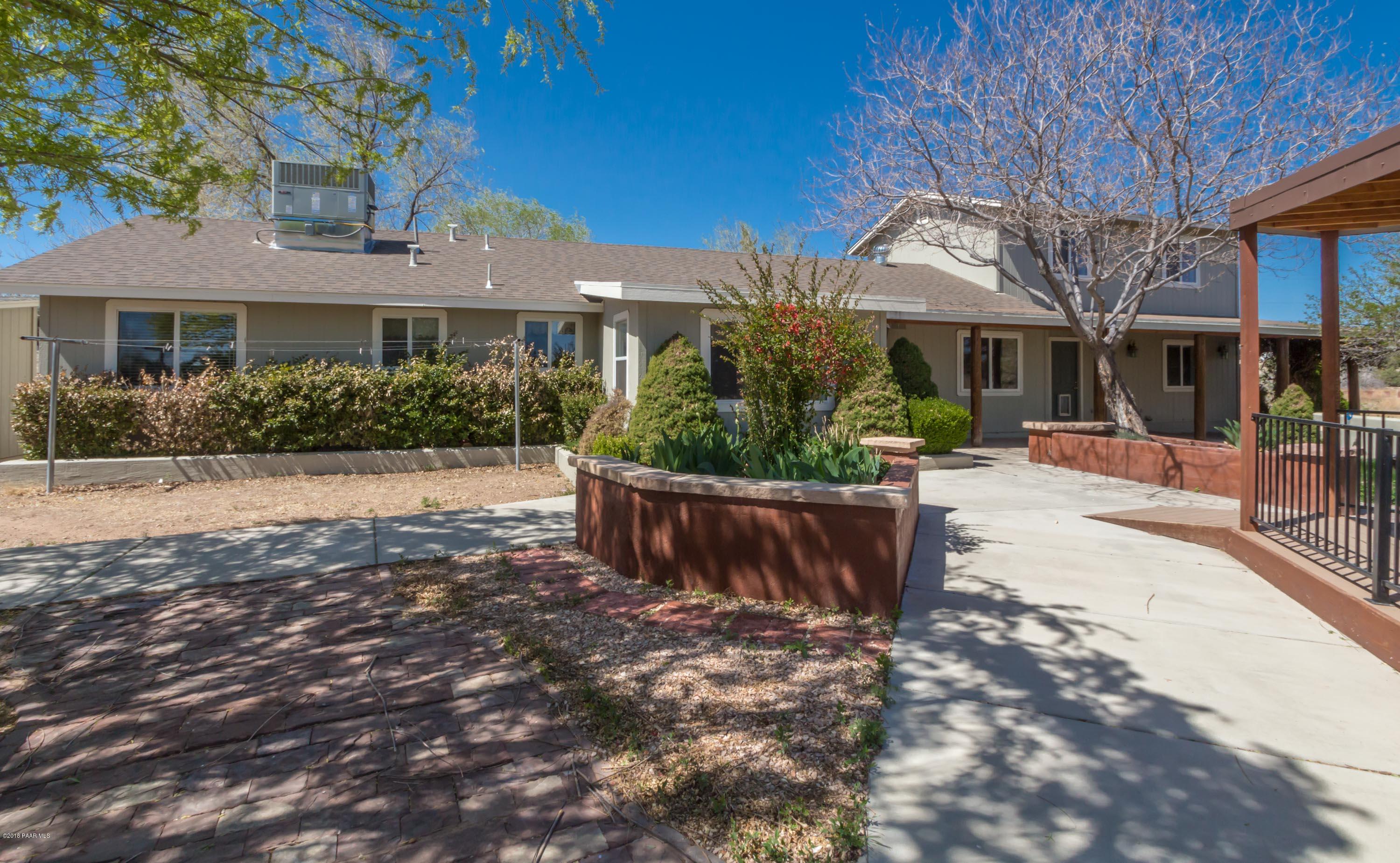 3887 North Reed Road Chino Valley, AZ 86323 - Photo 15 of 18 a front view of a house with a yard