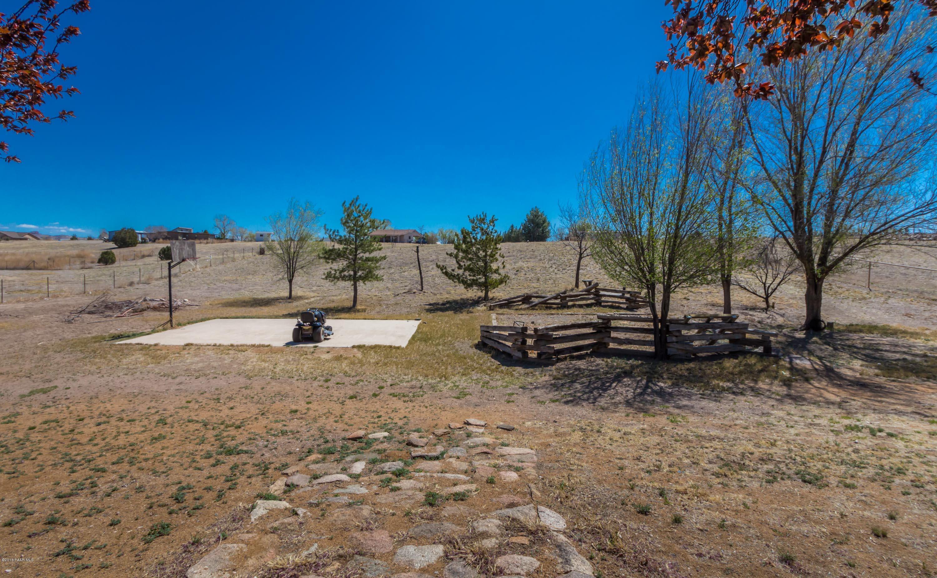 3887 North Reed Road Chino Valley, AZ 86323 - Photo 17 of 18 a view of a dry yard with trees