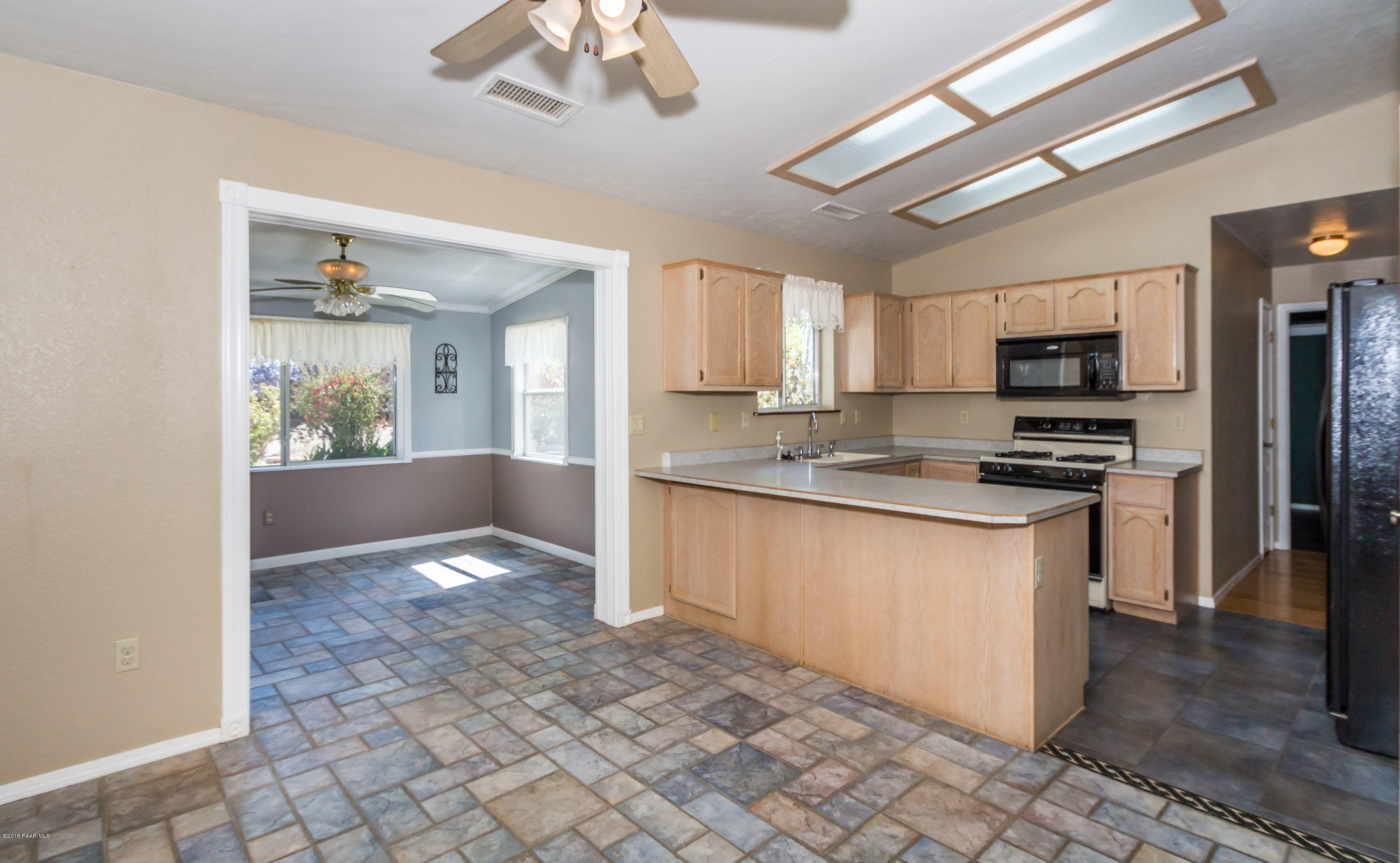 3887 North Reed Road Chino Valley, AZ 86323 - Photo 7 of 18 a kitchen with granite countertop a refrigerator stove top oven and sink