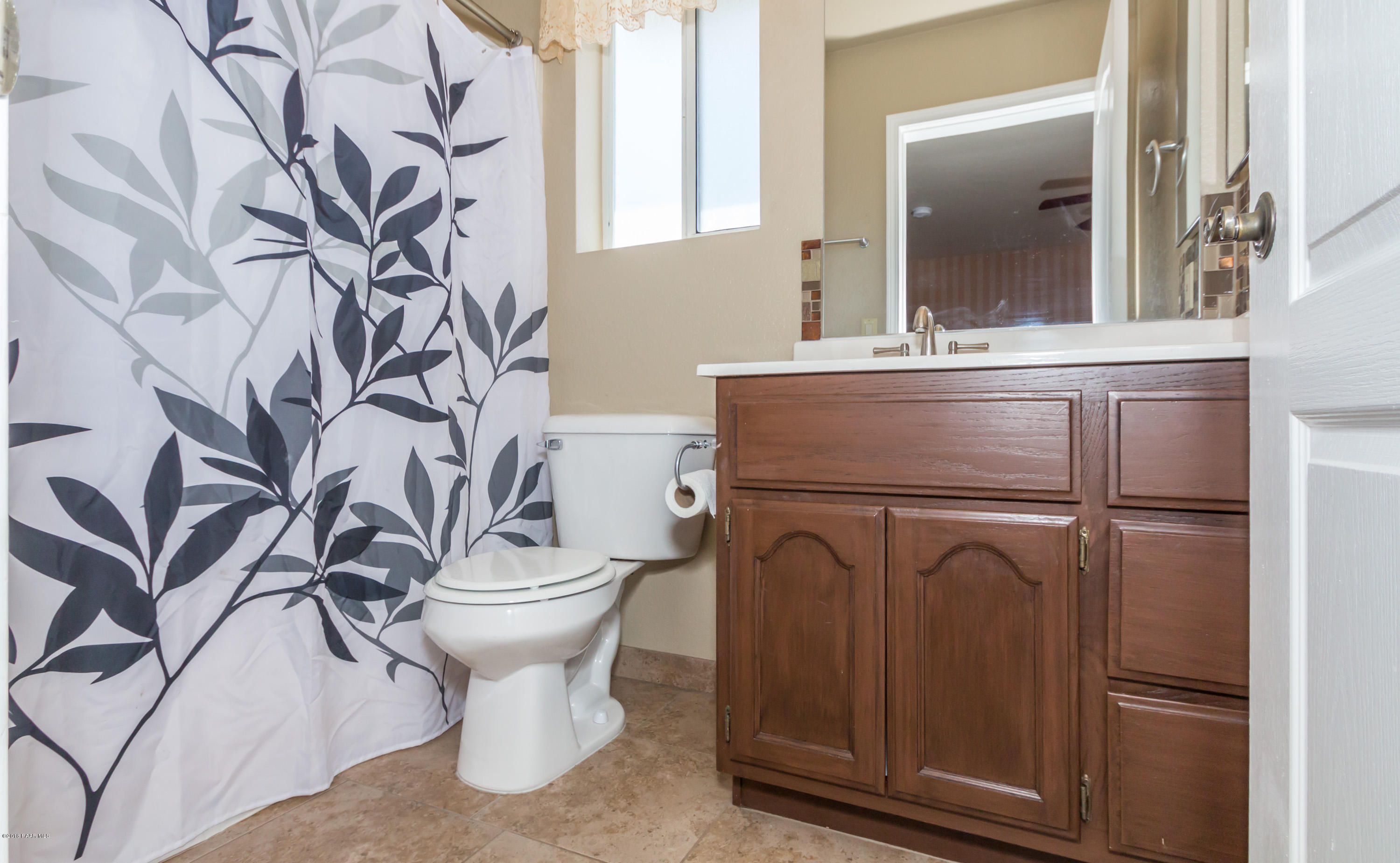 3887 North Reed Road Chino Valley, AZ 86323 - Photo 10 of 18 a bathroom with a sink toilet and mirror