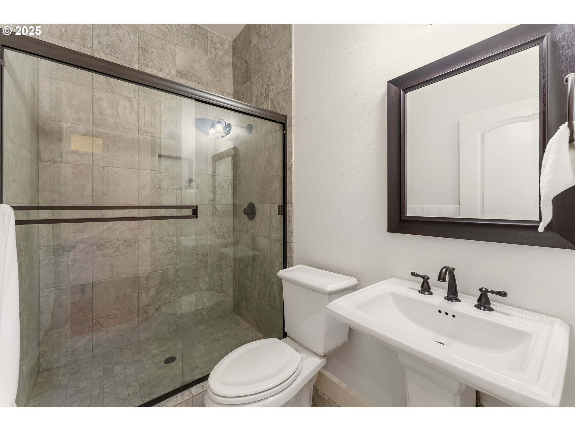 3356 Northwest 153rd Terrace Portland, OR 97229 - Photo 15 of 37 a bathroom with a sink toilet a mirror and shower