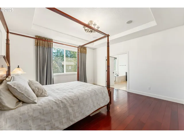 a bedroom with a bed and a window with the outer view