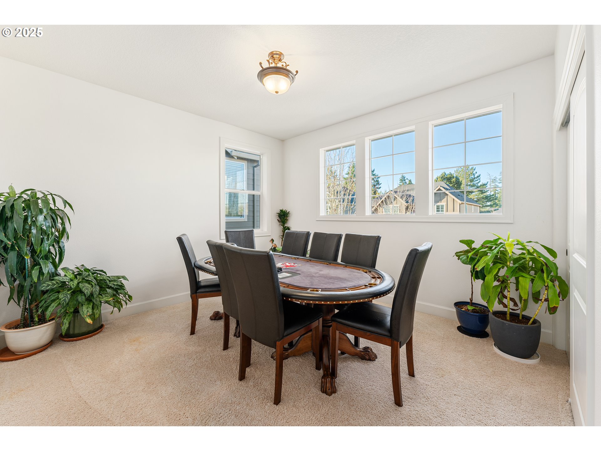 3356 Northwest 153rd Terrace Portland, OR 97229 - Photo 24 of 37 a dining room with furniture potted plants and wooden floor
