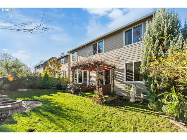 a view of a house with backyard and sitting area
