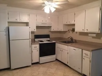 a kitchen with cabinets stainless steel appliances and a counter top space