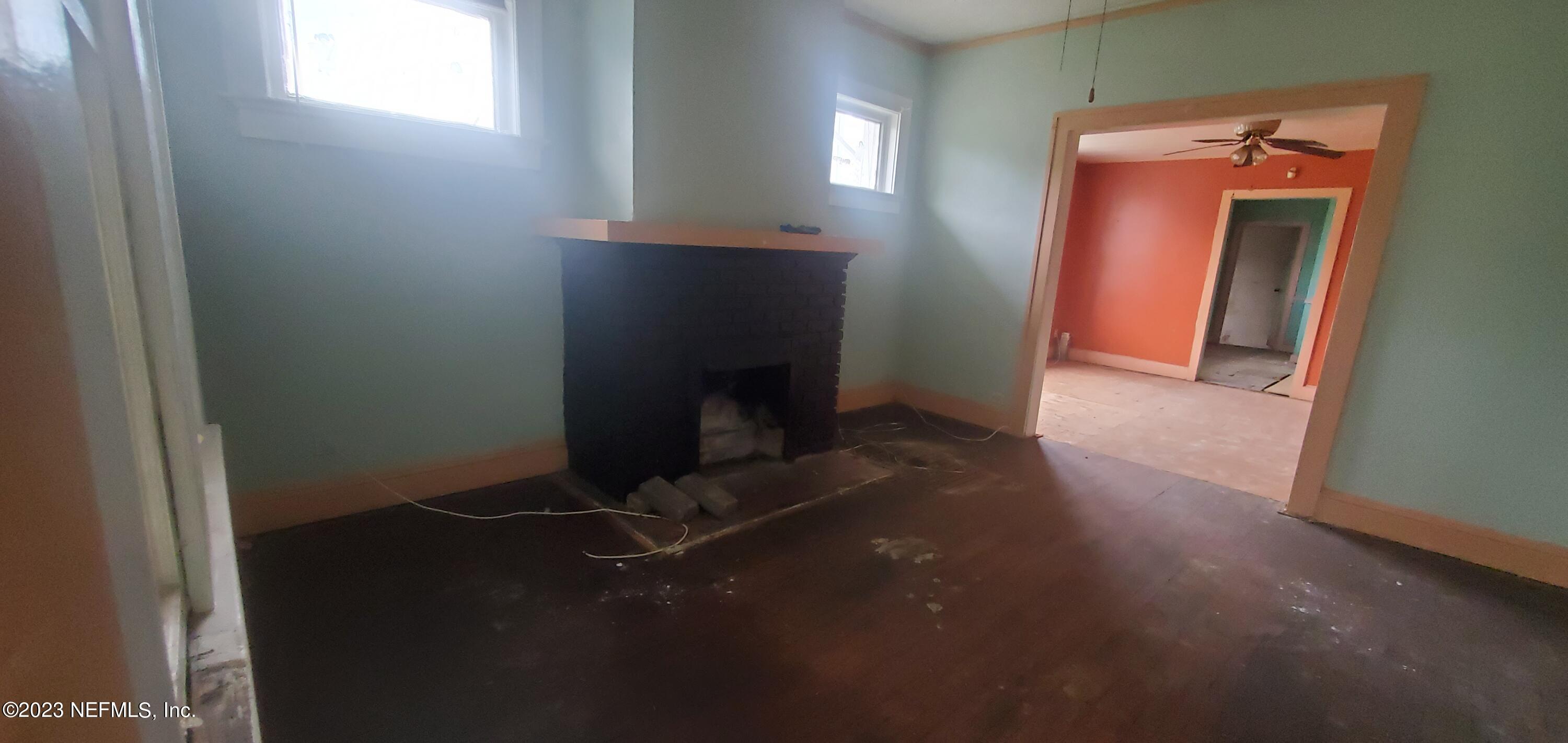 2363 Gilmore Street Jacksonville, FL 32204 - Photo 7 of 8 a view of an empty room with wooden floor and a window