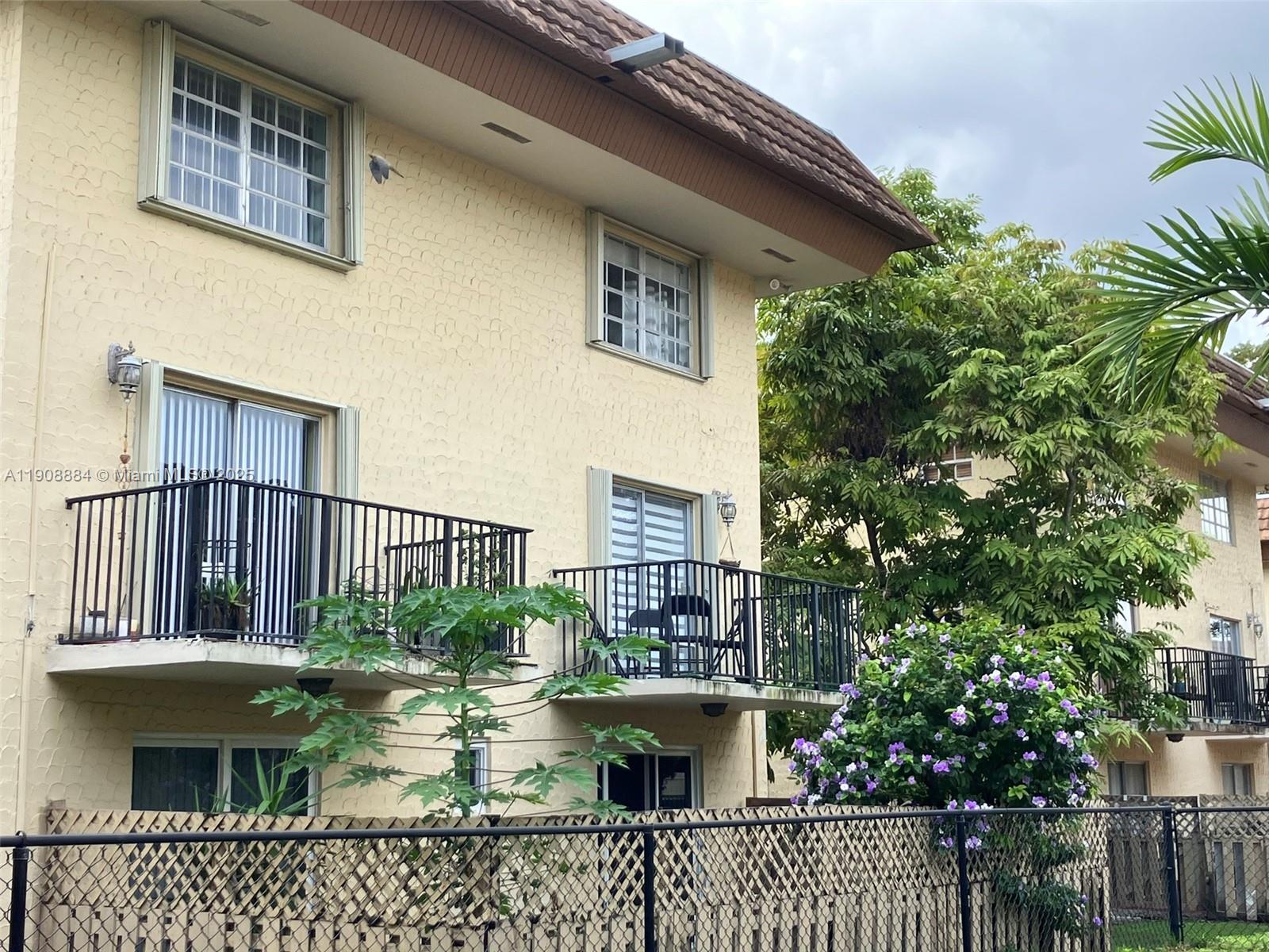 a view of a small yard and a wooden deck