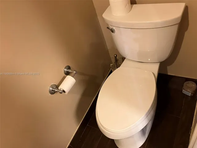 a view of staircase with lots of frames on wall and windows