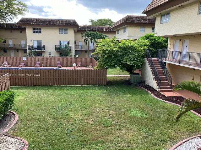 a view of swimming pool with outdoor seating and plants