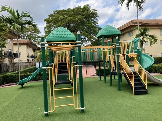 a view of a house with a park and a wooden fence