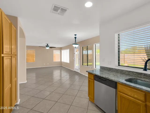 a view of a kitchen with a sink and a large window
