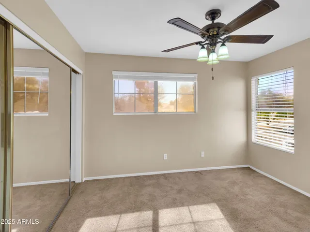 a view of a livingroom with a ceiling fan and window
