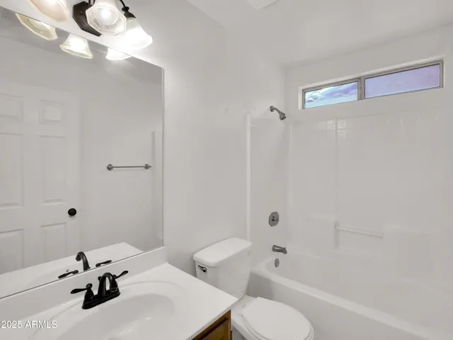 a bathroom with a sink a mirror and shower