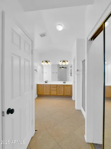 a spacious bathroom with a tub sink and mirror