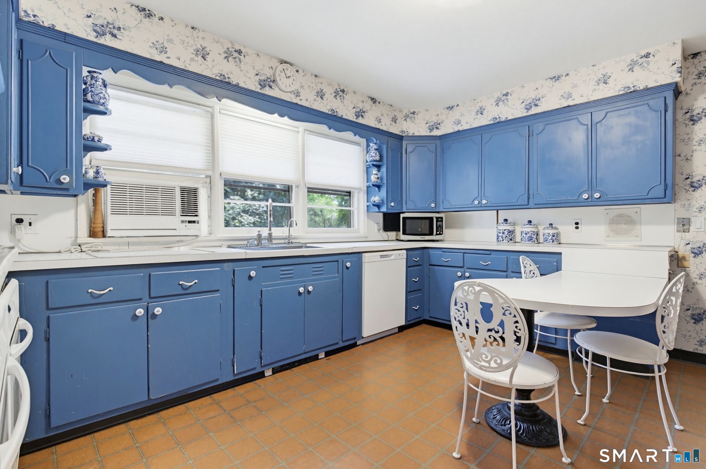 7 Sasqua Road Norwalk, CT 06855 - Photo 13 of 40 a kitchen with granite countertop wooden cabinets and white appliances