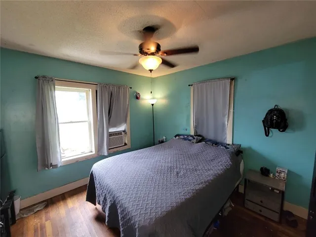 a bedroom with a bed window and a chandelier