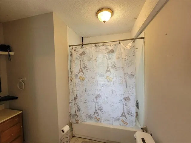 a bathroom with a shower curtain and a window