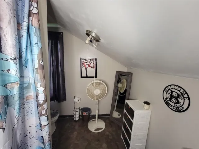 a bed room with a bed window and a chair