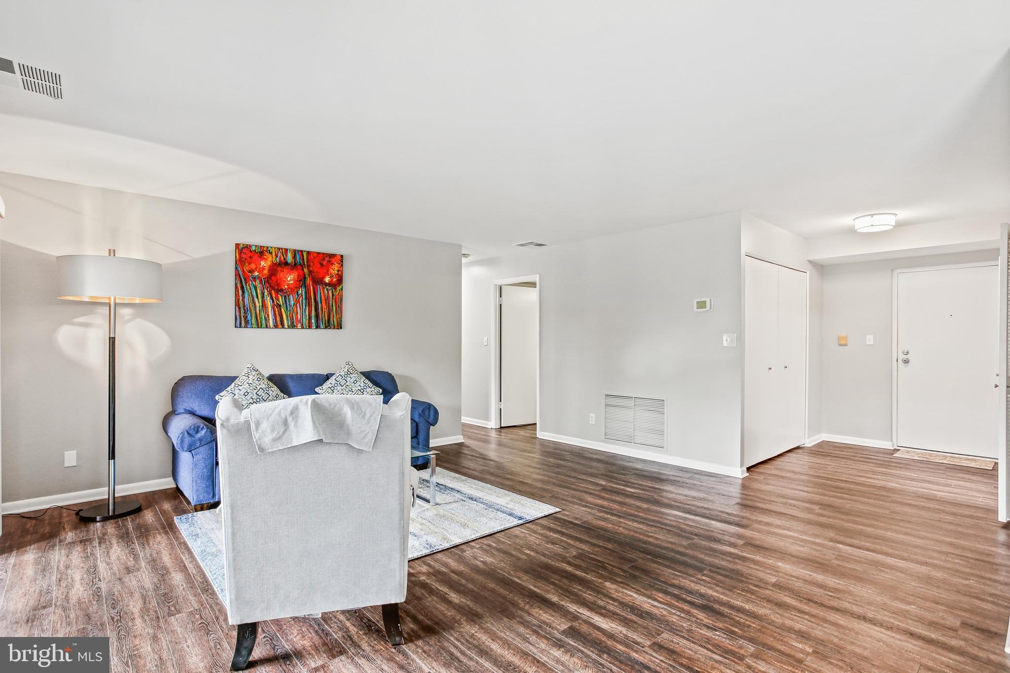 4 Candlemaker Court, Unit 301 Baltimore, MD 21208 - Photo 11 of 32 a living room with furniture and a wooden floor
