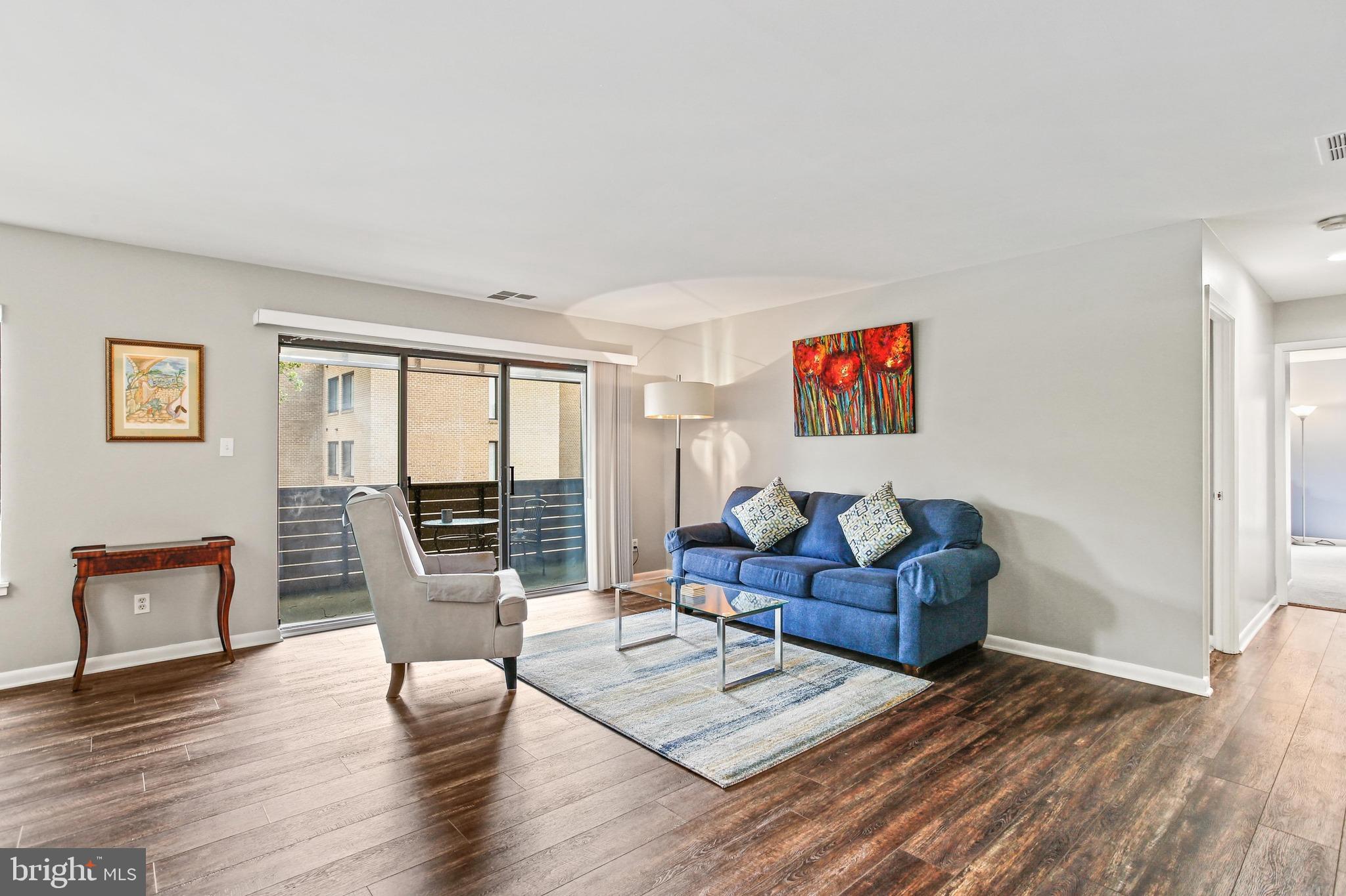4 Candlemaker Court, Unit 301 Baltimore, MD 21208 - Photo 13 of 32 a living room with furniture and wooden floor