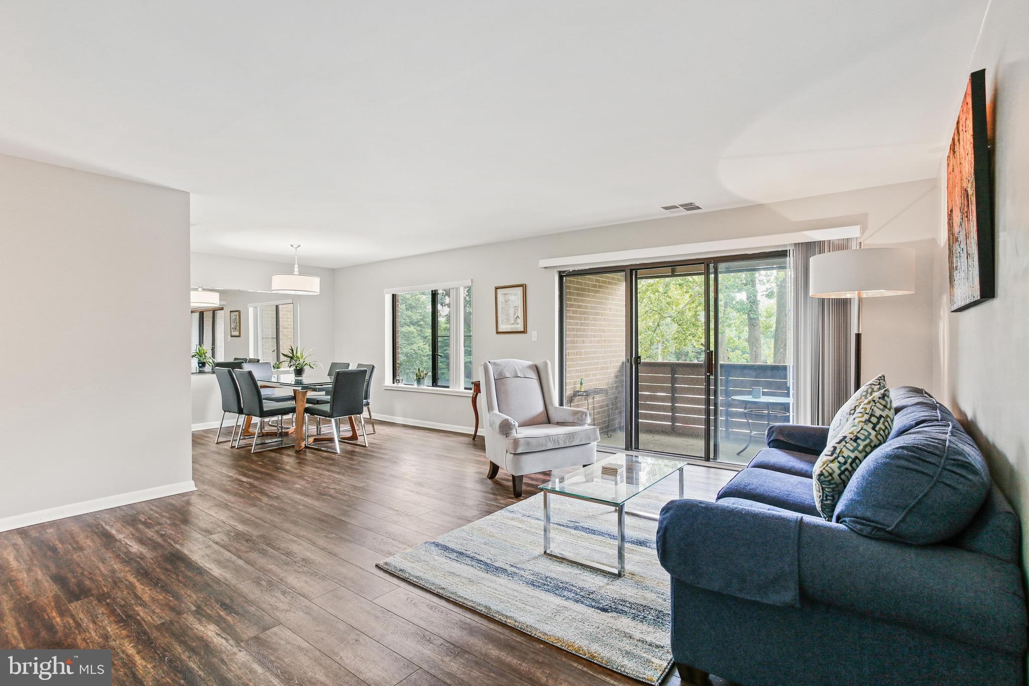 4 Candlemaker Court, Unit 301 Baltimore, MD 21208 - Photo 14 of 32 a living room with furniture and a large window