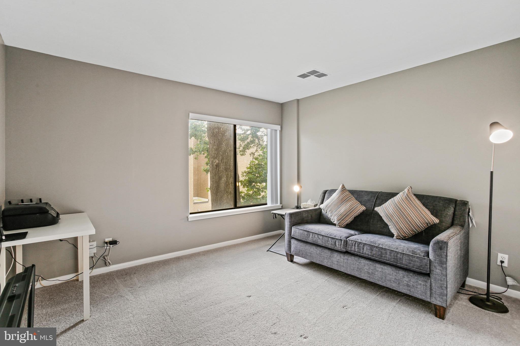 4 Candlemaker Court, Unit 301 Baltimore, MD 21208 - Photo 15 of 32 a living room with furniture and a window