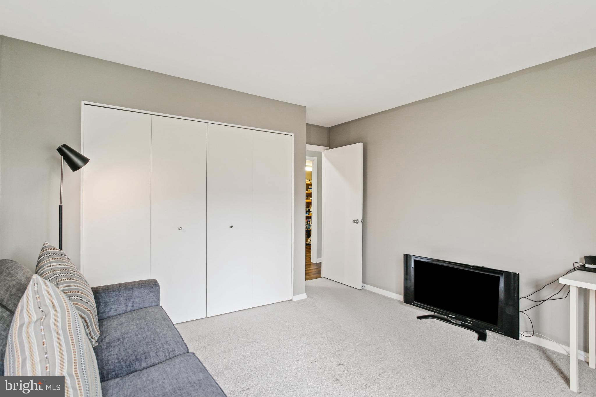 4 Candlemaker Court, Unit 301 Baltimore, MD 21208 - Photo 16 of 32 a living room with furniture and a flat screen tv