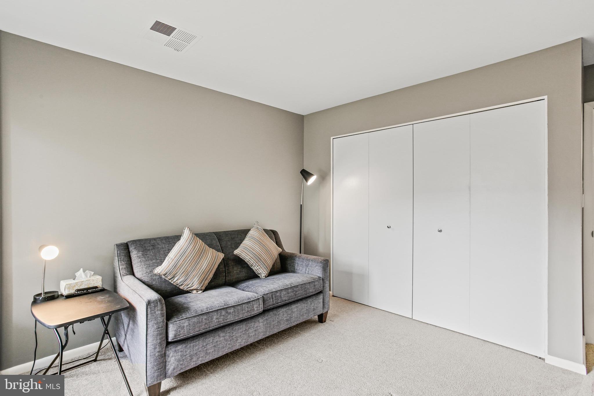 4 Candlemaker Court, Unit 301 Baltimore, MD 21208 - Photo 17 of 32 a living room with furniture and a couch