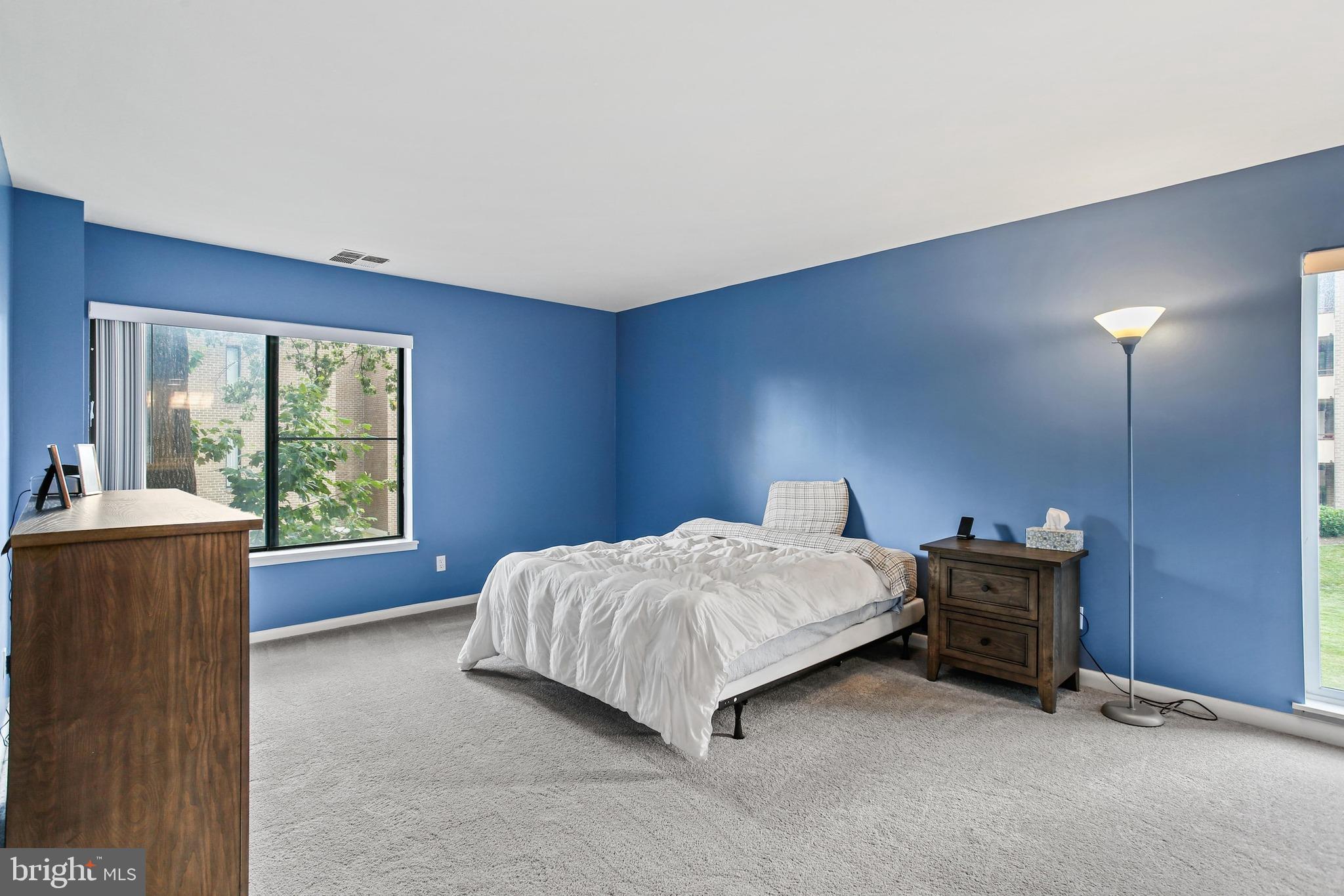 4 Candlemaker Court, Unit 301 Baltimore, MD 21208 - Photo 18 of 32 a bedroom with a bed and a window