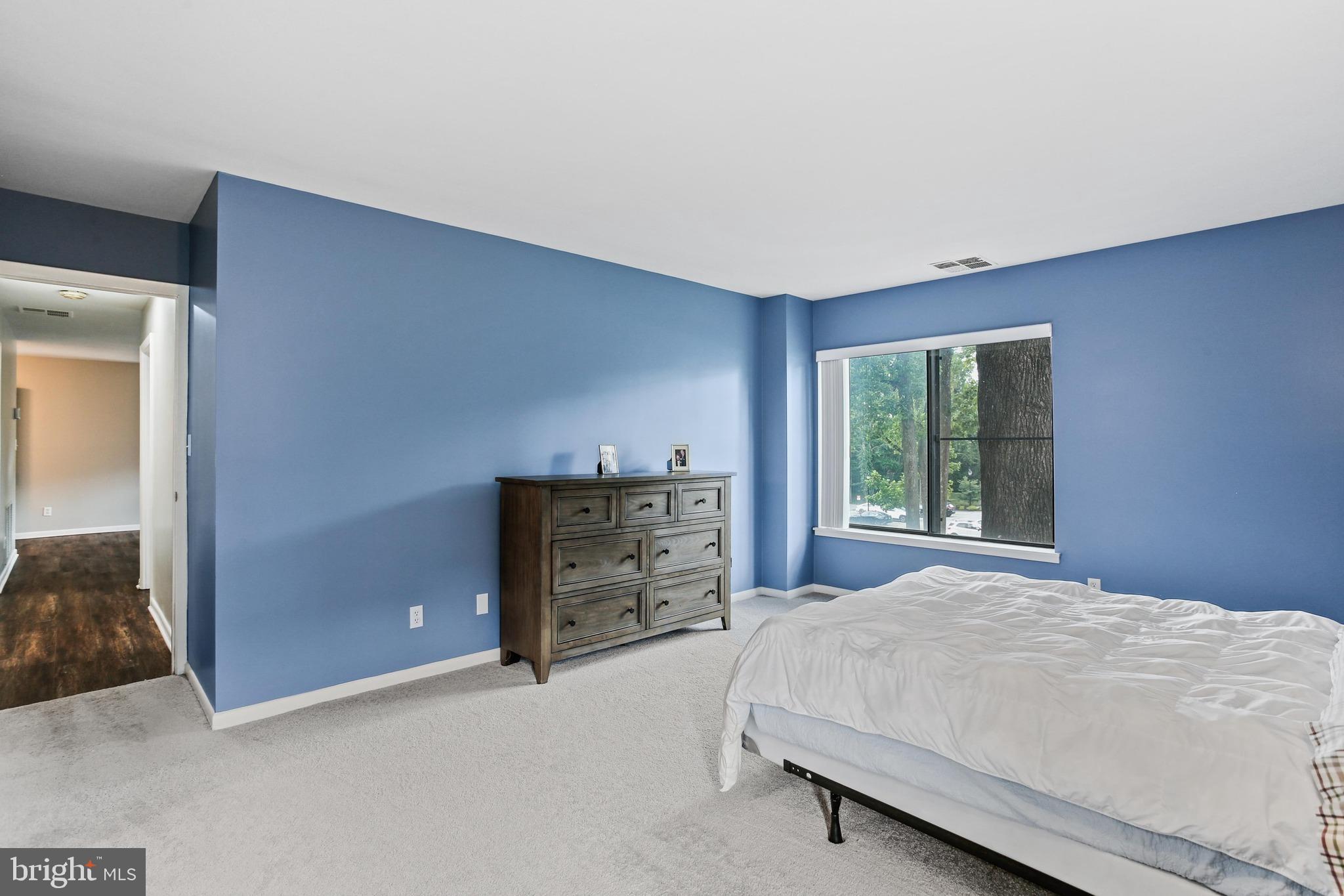 4 Candlemaker Court, Unit 301 Baltimore, MD 21208 - Photo 19 of 32 a bedroom with a bed and a window