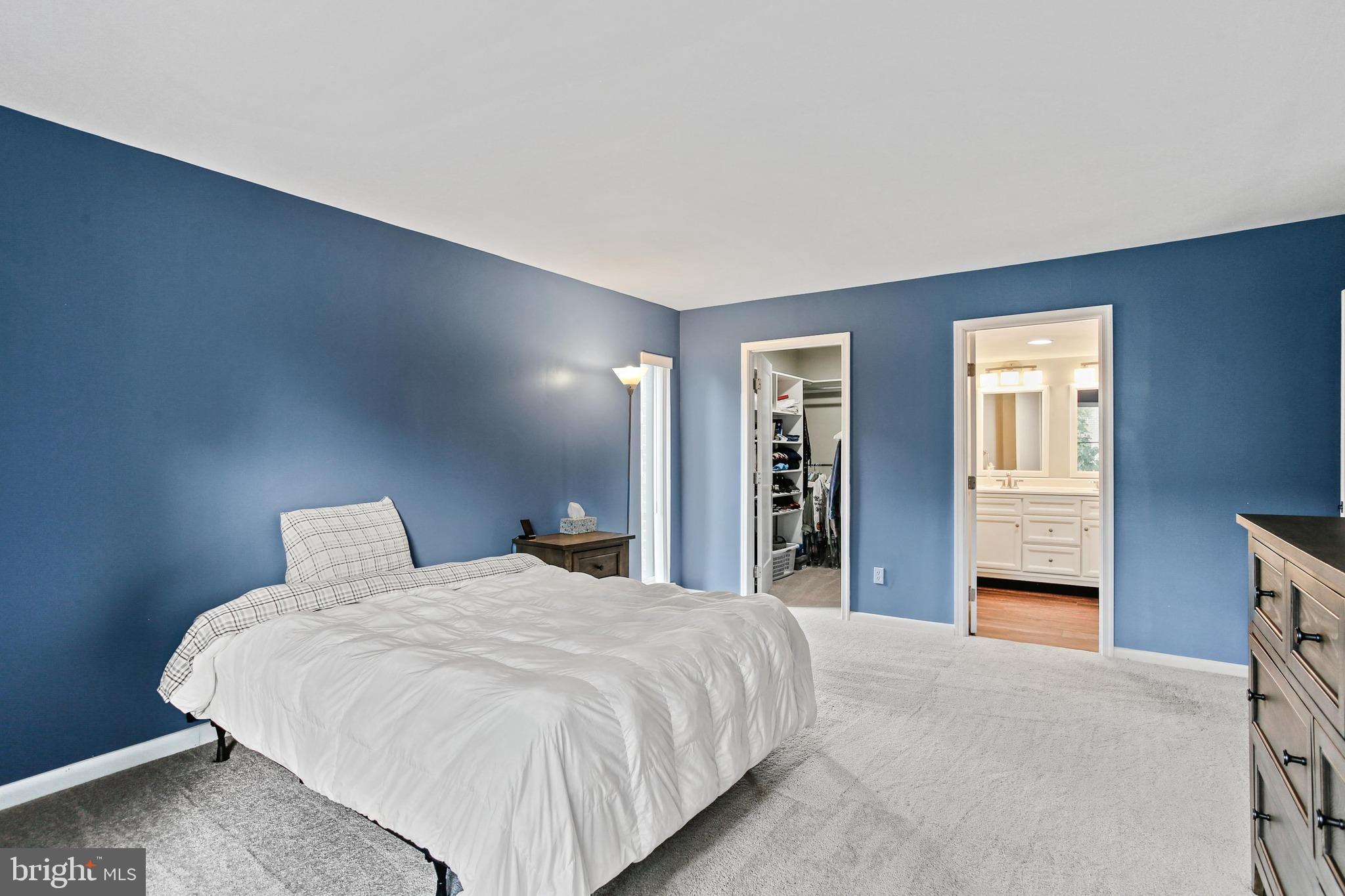 4 Candlemaker Court, Unit 301 Baltimore, MD 21208 - Photo 20 of 32 a large bed sitting in a bedroom and closet