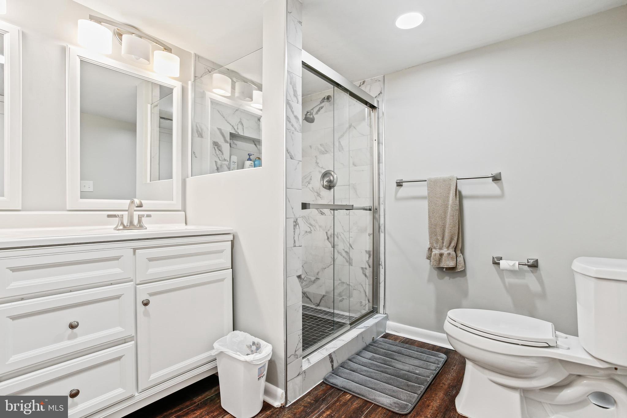 4 Candlemaker Court, Unit 301 Baltimore, MD 21208 - Photo 23 of 32 a bathroom with a sink a toilet and shower