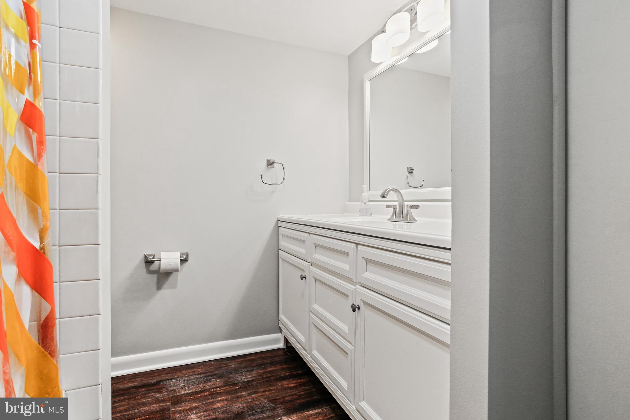 4 Candlemaker Court, Unit 301 Baltimore, MD 21208 - Photo 24 of 32 a bathroom with a sink and a mirror