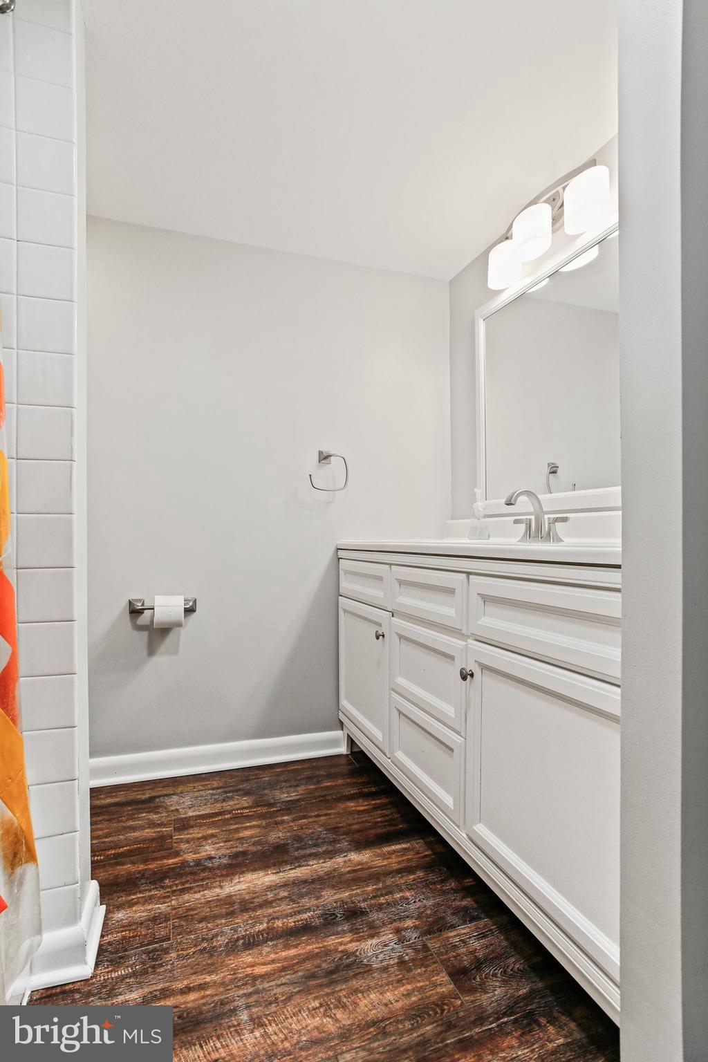 4 Candlemaker Court, Unit 301 Baltimore, MD 21208 - Photo 25 of 32 a bathroom with a sink and mirror