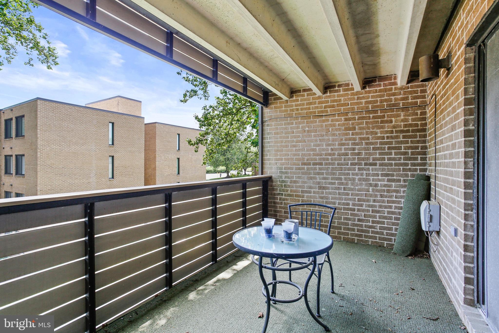 4 Candlemaker Court, Unit 301 Baltimore, MD 21208 - Photo 27 of 32 a view of a chairs and a table in the balcony