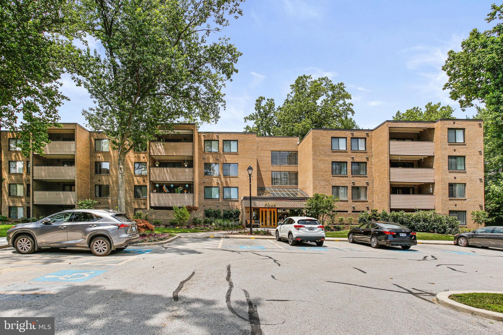 4 Candlemaker Court, Unit 301 Baltimore, MD 21208 - Photo 31 of 32 a city street lined with parked cars and buildings