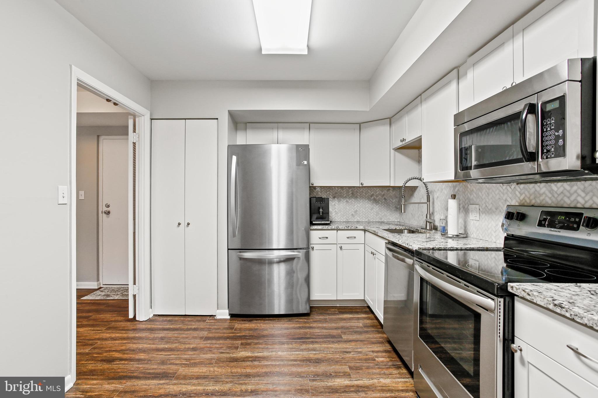 4 Candlemaker Court, Unit 301 Baltimore, MD 21208 - Photo 7 of 32 a kitchen with a refrigerator stove and microwave