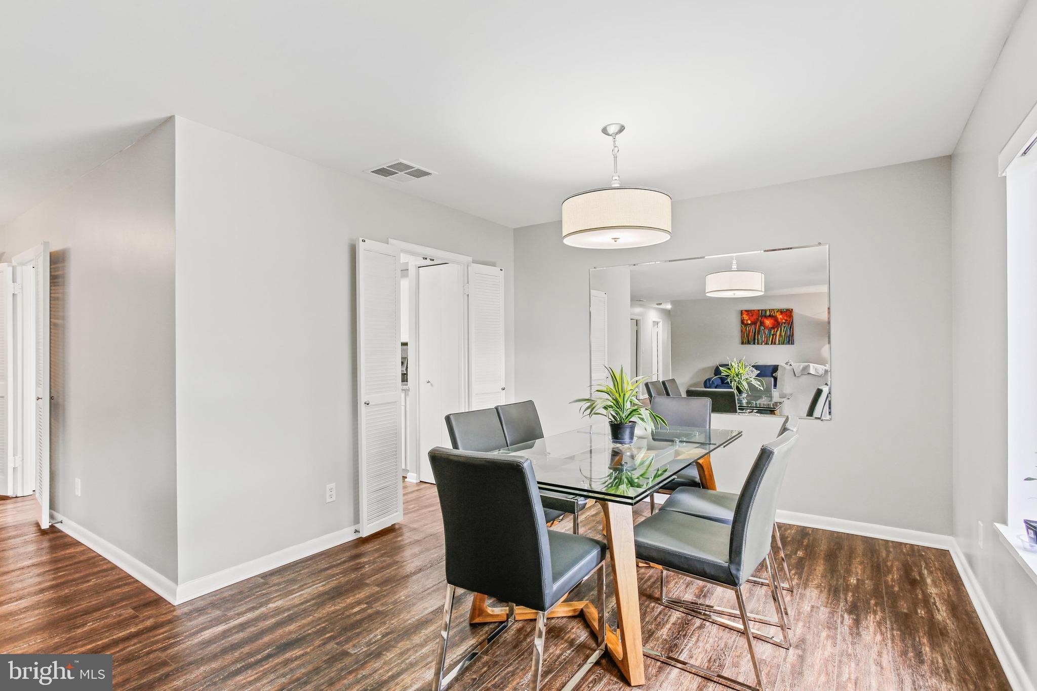 4 Candlemaker Court, Unit 301 Baltimore, MD 21208 - Photo 9 of 32 a view of a dining room with furniture wooden floor and chandelier