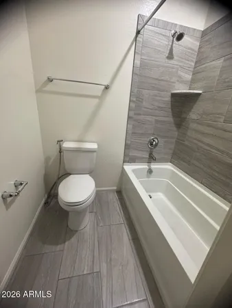 a bathroom with a granite countertop bathtub and toilet