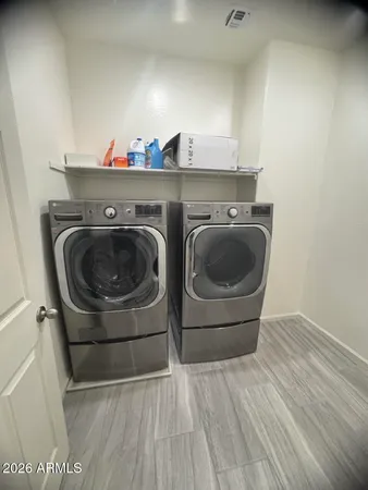 a utility room with wooden floor and cabinets